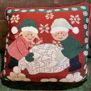 Christmas throw pillow with boy and girl building an igloo
